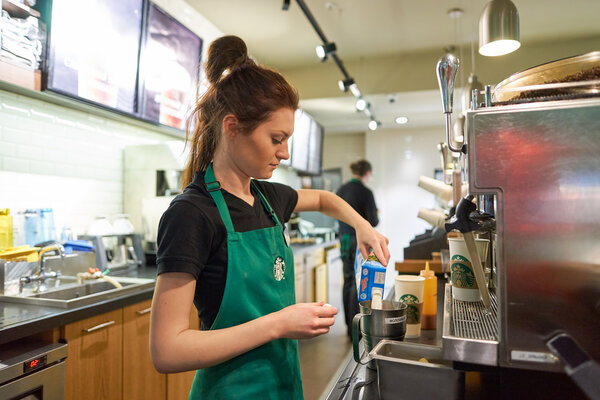 Worker at Starbucks Cafe