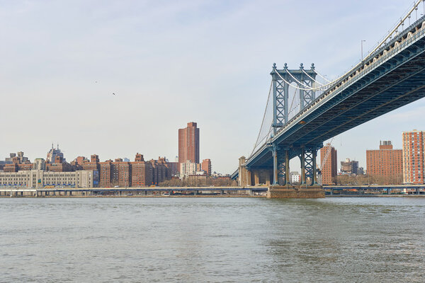 NEW YORK - CIRCA MARCH, 2016: Manhattan Bridge in the daytime. The Manhattan Bridge is a suspension bridge that crosses the East River in New York City