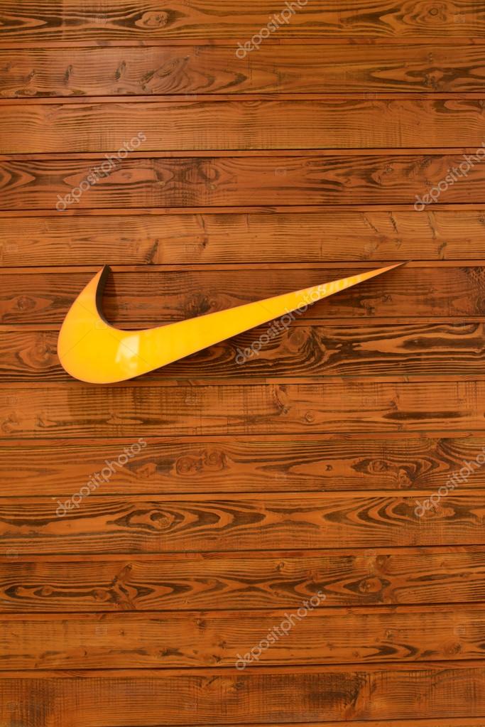HONG KONG - APRIL 02: Nike, Inc. logo on wooden wall on April 02, 2014 in Hong Kong. The company was founded on January 25, 1964, as Blue Ribbon Sports, by Bill Bowerman and Phil Knight, and officially became Nike, Inc. on May 30, 1971.