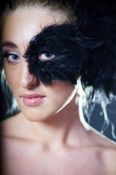 Woman with black feather half mask — Stock Photo, Image