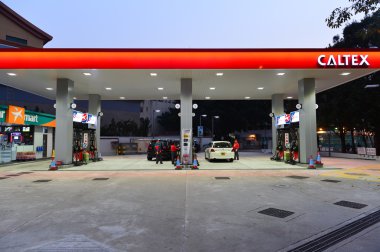 Caltex fuel station at evening clipart