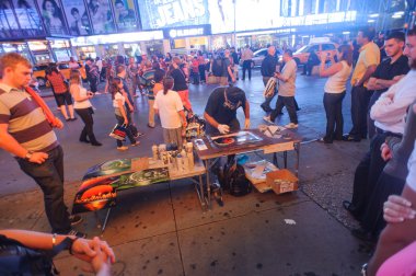 Artist on  Times Square at night
