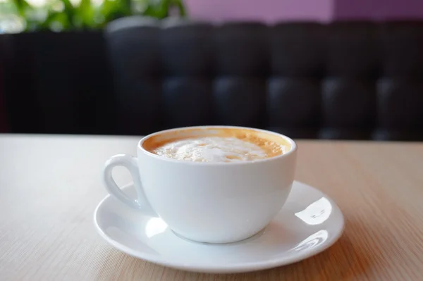 Cup with hot latte — Stock Photo, Image