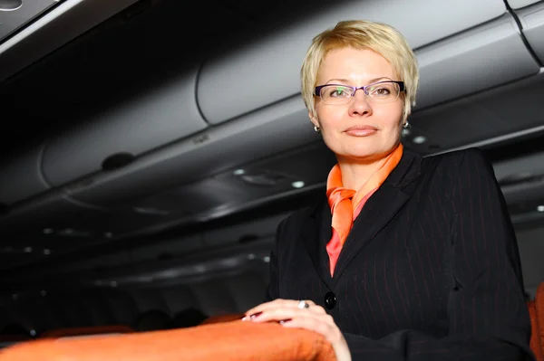 Businesswoman posing in  jet aircraft — Stock Photo, Image