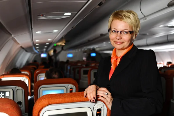 Businesswoman posing in  jet aircraft — Stock Photo, Image