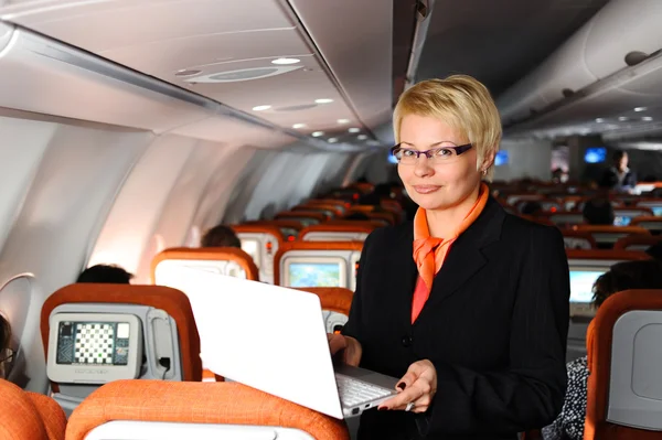 Businesswoman posing in  jet aircraft — Stock Photo, Image