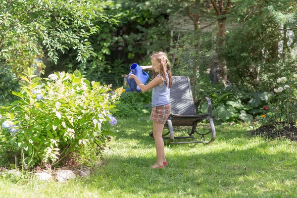 Girl watering flowers — Stock Photo, Image