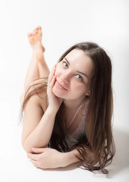 Girl lying on a white background — Stock Photo, Image