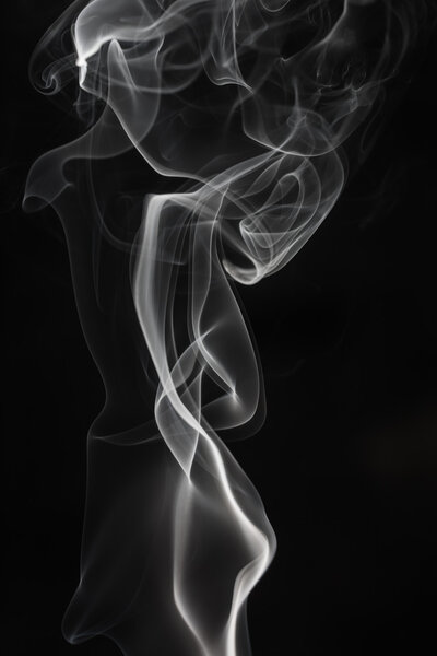 Smooth white smoke on a black background, abstract