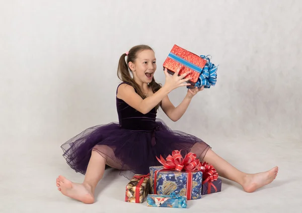 Girl rejoices boxes with gifts — Stock Photo, Image