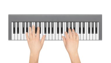 Hands playing electronic piano on a white background. View from  clipart