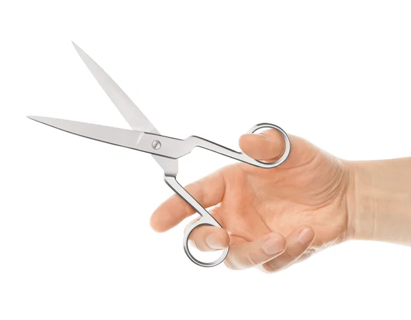 Nůžky v ruce něco řez na bílém pozadí — Stock fotografie