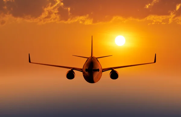 Passenger airplane flying in the evening or morning sky — Stock Photo, Image