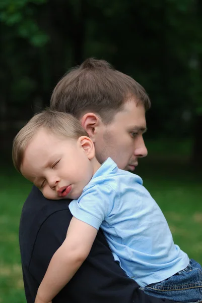 Little child asleep on dad's shoulder Royalty Free Stock Photos