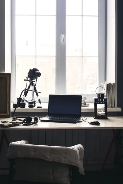 在现代的木桌上，倾斜笔记本在家庭内部，桌上的黑色屏幕的打开笔记本电脑工作场所过滤图像 — 图库照片