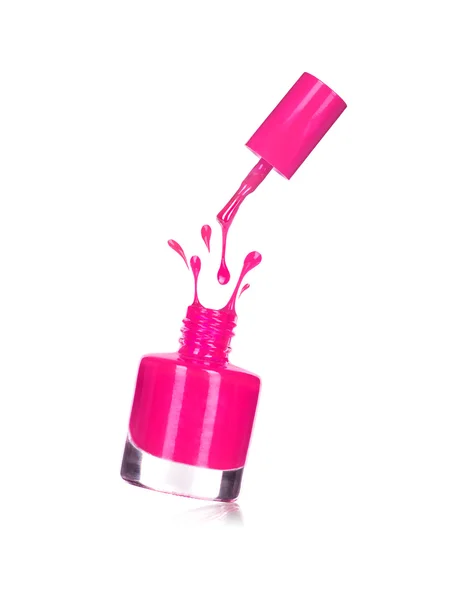 Pink nail polish bottle with splash isolated on white — Stock Photo, Image