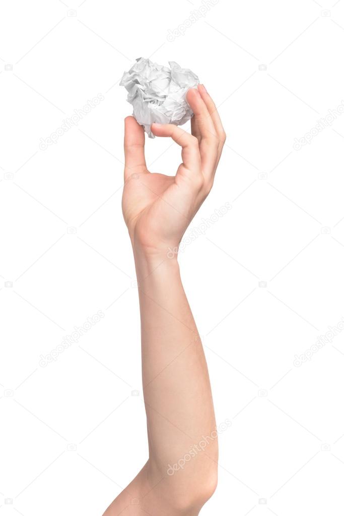 human hand holding paper ball shooting in studio