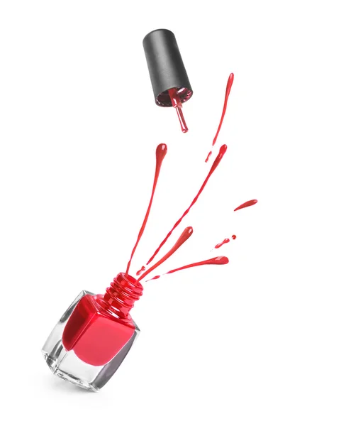 Red nail polish bottle with splash isolated on white — Stock Photo, Image