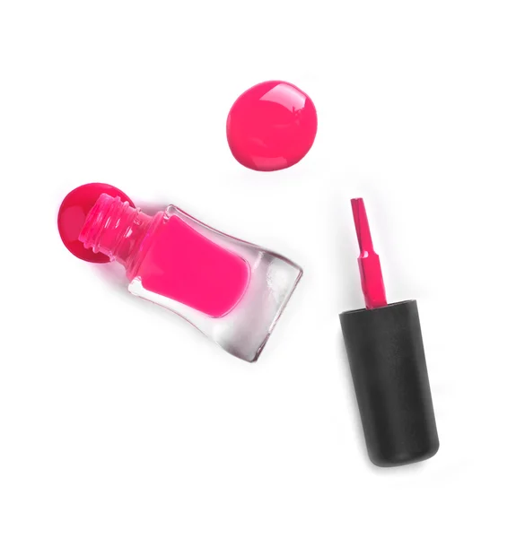 Pink nail Polish in the bottle near the hand and a little spille — Stock Photo, Image