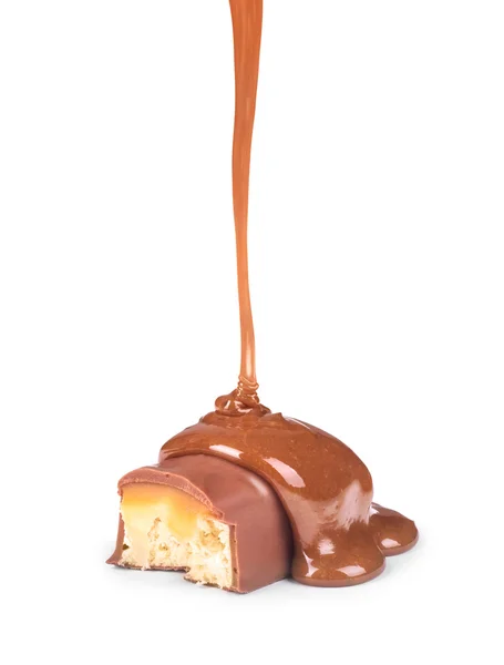 Molho de caramelo doce é derramado em uma barra de chocolate — Fotografia de Stock