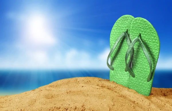 Colorful flip flops on beach against sunny sky — Stock Photo, Image