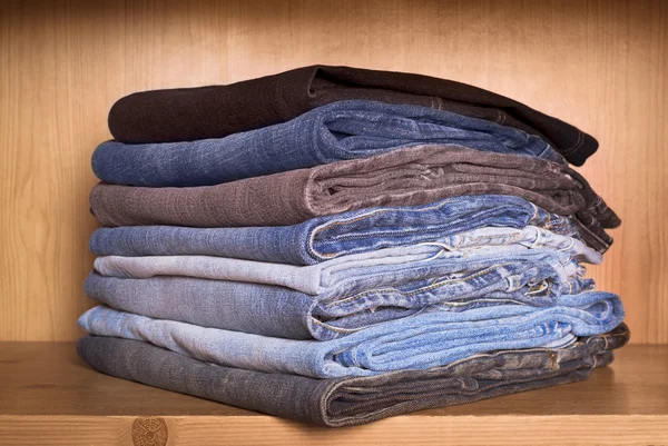 Jeans on a wooden shelf — Stock Photo, Image