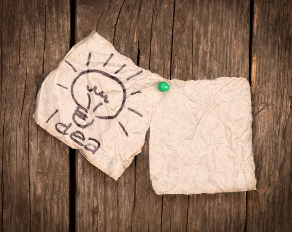 Pieces of paper with the word idea on a wooden background — Stock Photo, Image