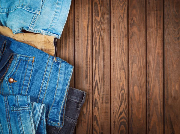 Jeans on a wooden background — Stock Photo, Image