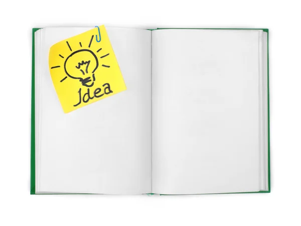Livro aberto com a folha anexada com a inscrição "ideia " — Fotografia de Stock