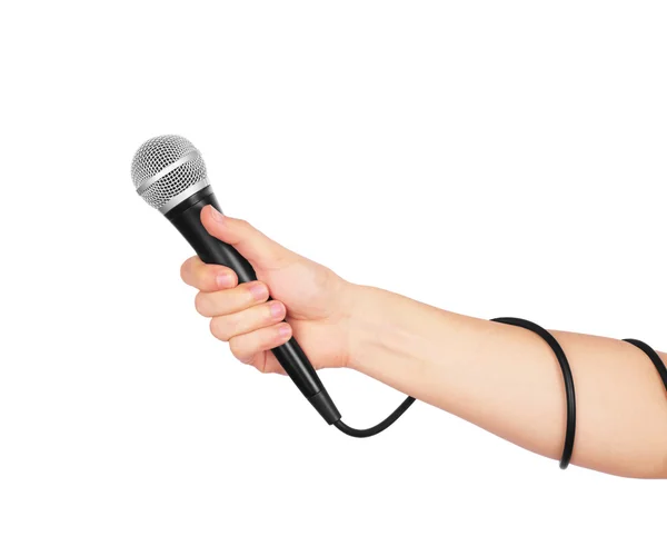 Main féminine avec microphone, sur fond blanc . — Photo