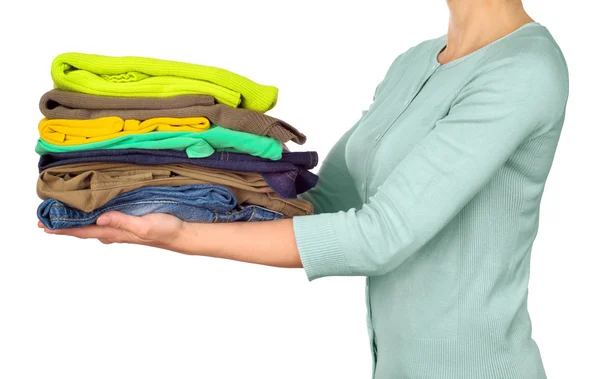 Woman hold clothes pile against white background — Stock Photo, Image