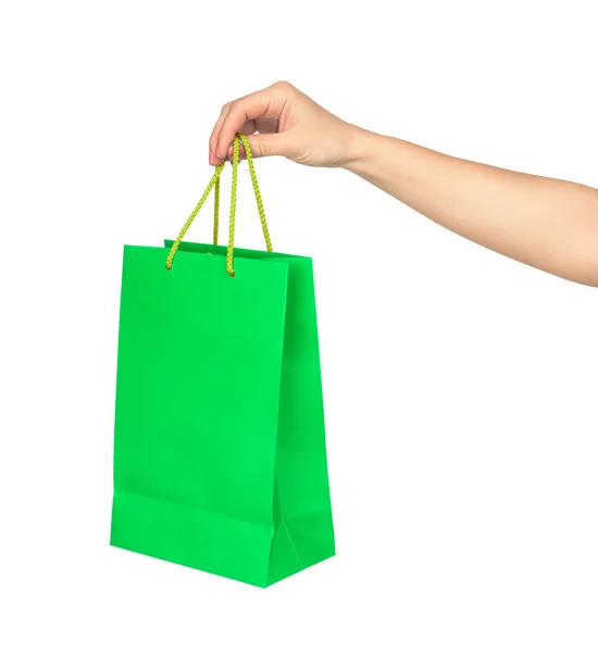 La main tient un sac vert vif pour faire du shopping isolé sur blanc — Photo