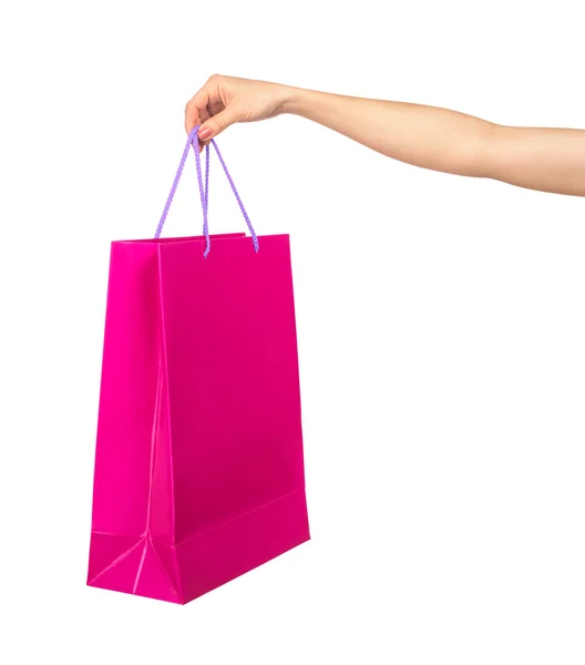 Female hand holding a crimson gift bag isolated on white backgro — Stock Photo, Image