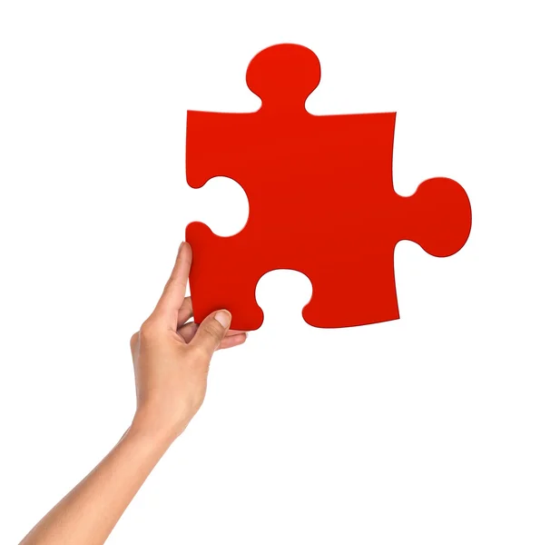 Female hand holding red puzzle on an isolated white background — Stock Photo, Image