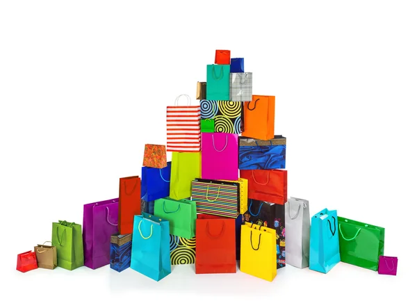 Una enorme pila de bolsas multicolores para ir de compras aisladas en blanco —  Fotos de Stock
