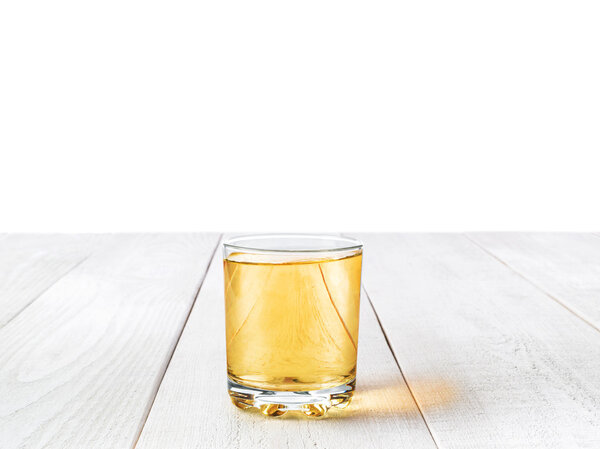 a glass of Apple juice on the white Desk isolated on white backg