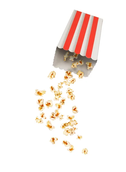 Popcorn with flying kernels from red white cardboard box — Stock Photo, Image