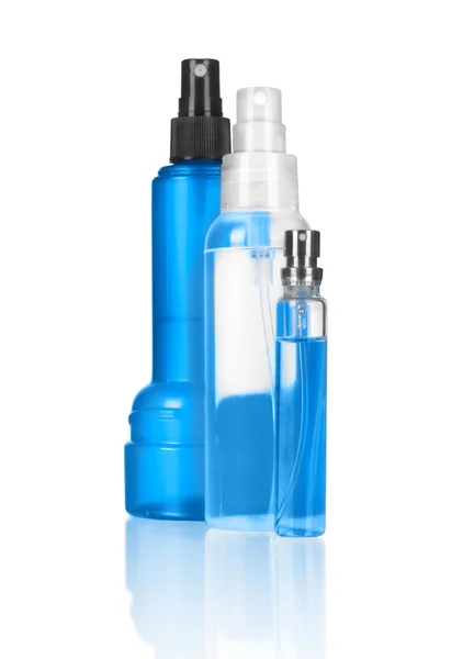 Tres botellas de spray sobre un fondo blanco — Foto de Stock