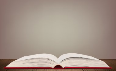 Tahta bir masanın üzerinde açık bir kitap.