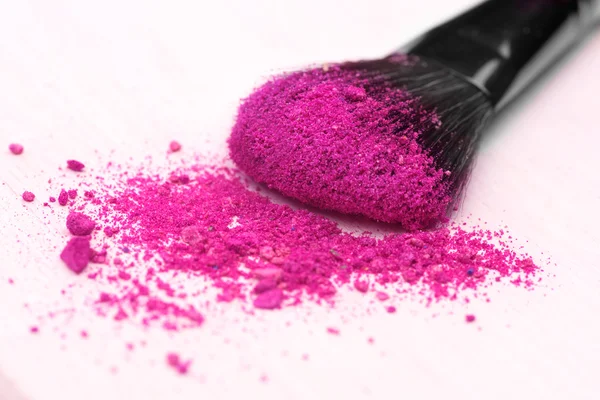 Make-up brush on pink crushed eyeshadow — Stock Photo, Image