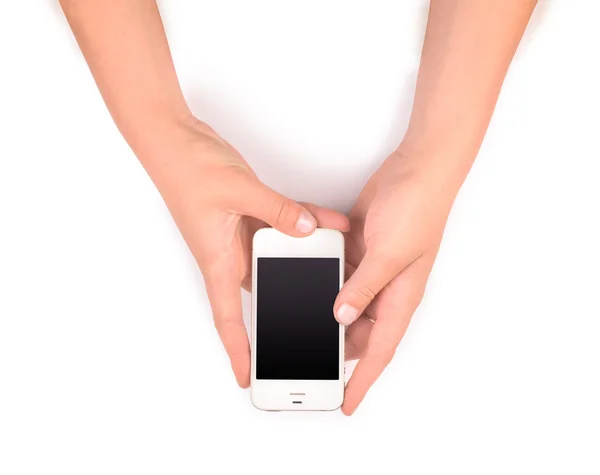 Téléphone dans les mains féminines sur blanc — Photo