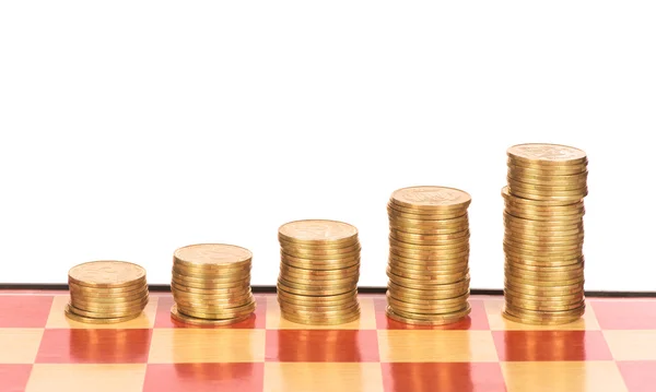 Chessboard with stacks of pennies Royalty Free Stock Photos