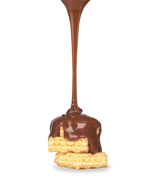 On vanilla wafer pouring chocolate on white background — Stock Photo, Image