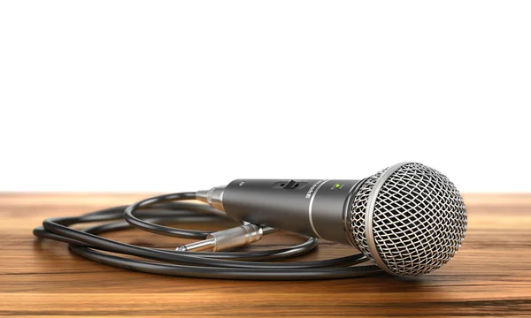 Microphone with cable on a wood background. — Stock Photo, Image