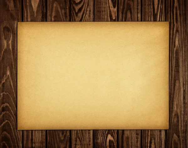 Kraft paper on a wooden background — Stock Photo, Image