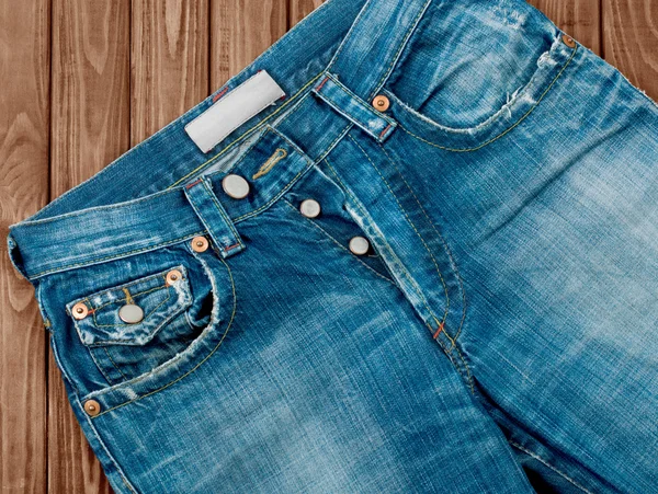 Close-up of denim shorts on a background of trees — Stock Photo, Image