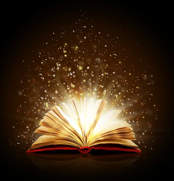 Open magic book with magic lights on a black background — Stock Photo, Image