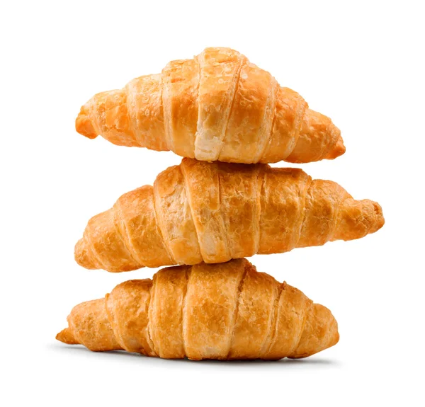 Pile of fresh and delicious croissants on a white background — Stock Photo, Image