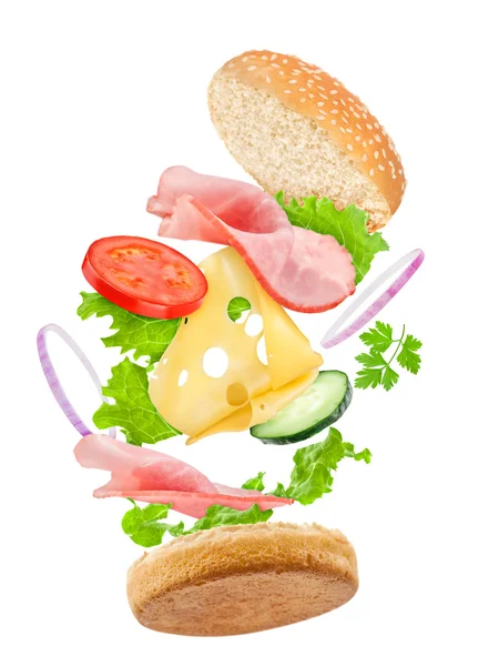 Spadające pyszne kanapki z składników: szynka, ser, pomidor — Zdjęcie stockowe