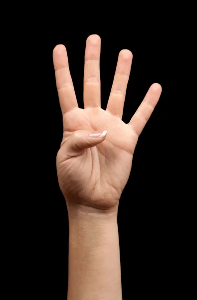 Female hand showing number four on a black background — Stock Photo, Image